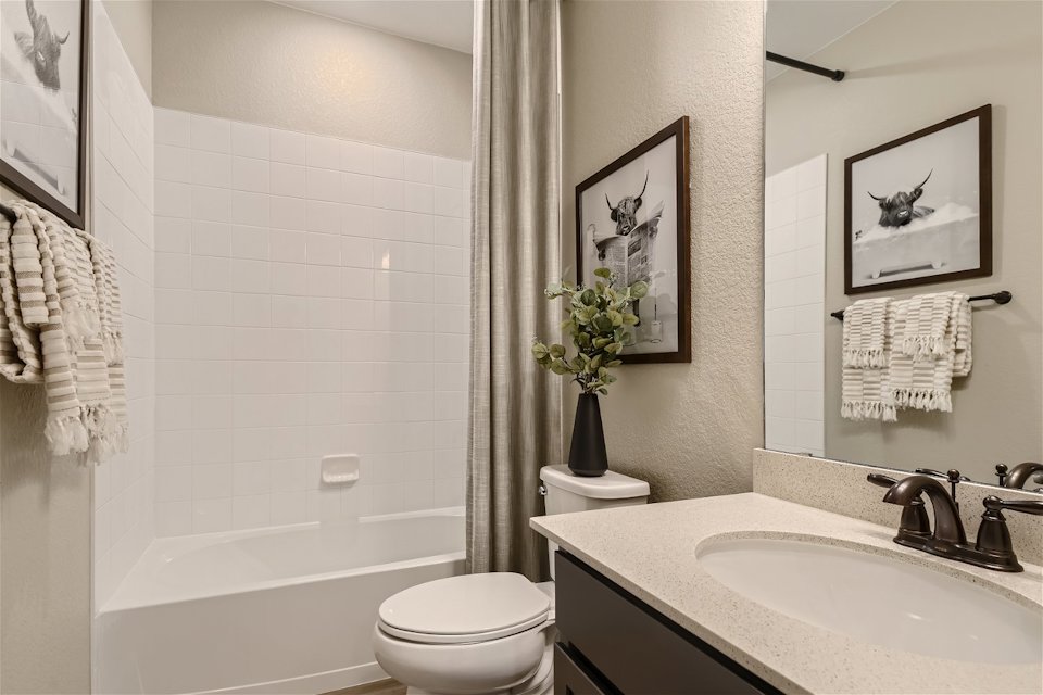 A bathroom with a sink toilet and a bathtub.