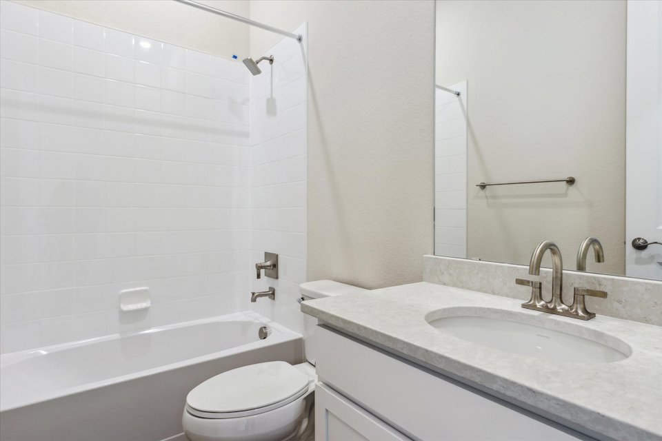 A bathroom with a sink toilet and bathtub.