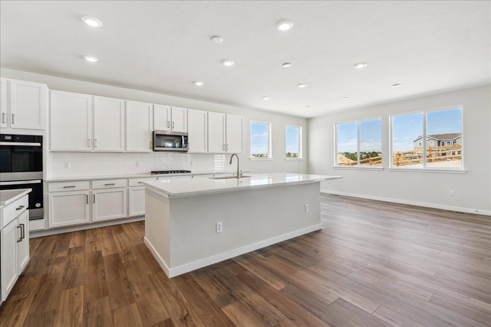 A kitchen with white cabinets.