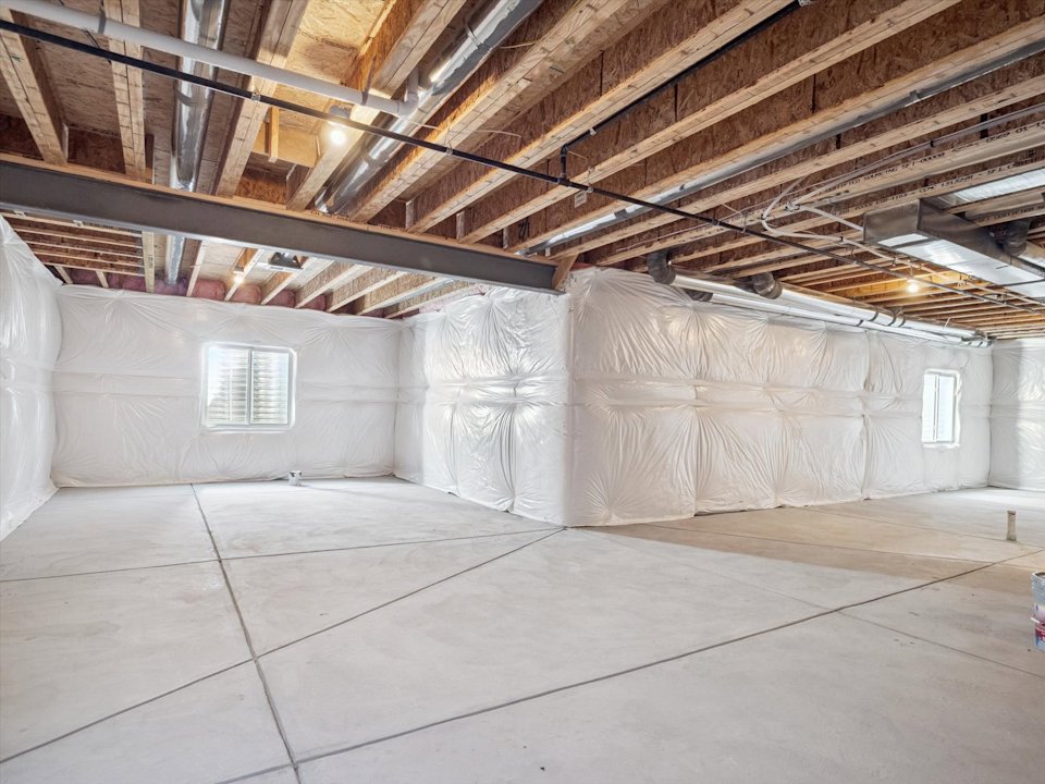 A room with a tile floor and a white wall with a window.