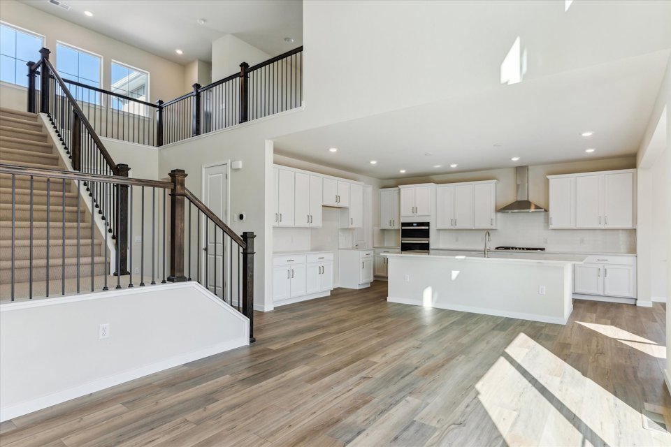 A large white kitchen with white cabinets.