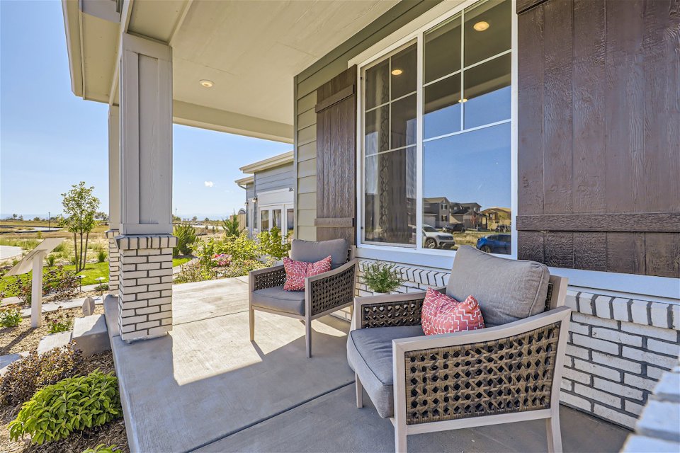 A patio with chairs and a table.