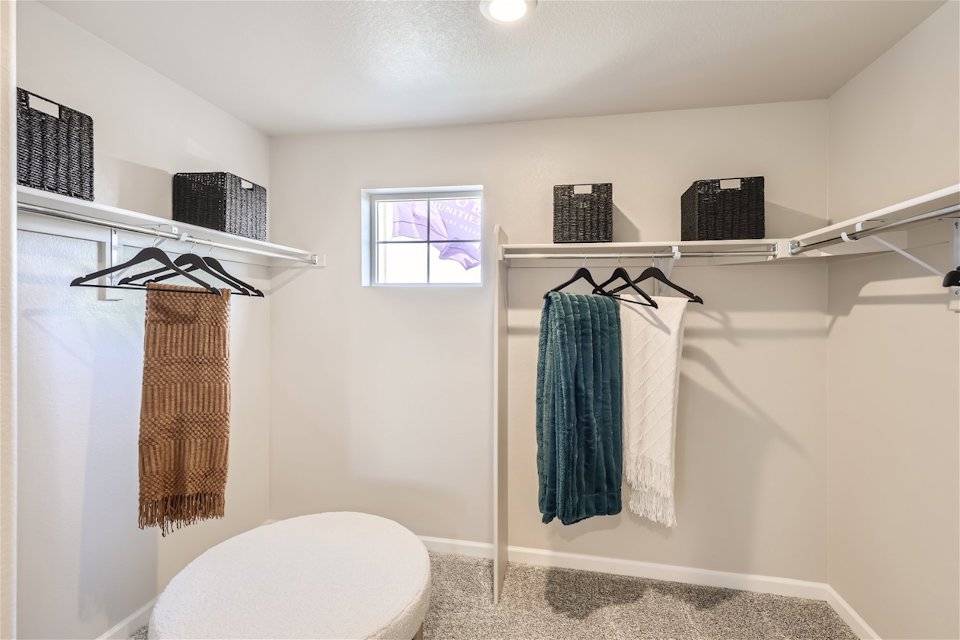 A bathroom with a toilet and towels.
