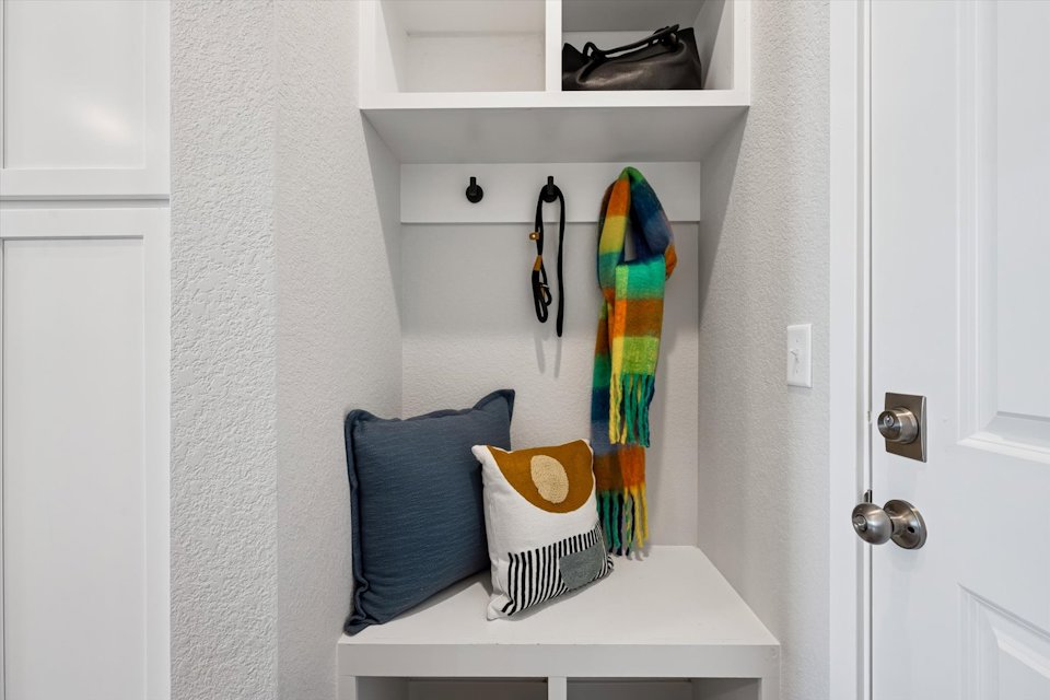 A closet with a couple of towels and a pair of shoes.