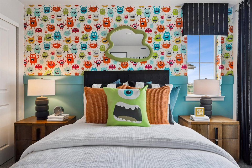 A bedroom with a bed and a mirror.