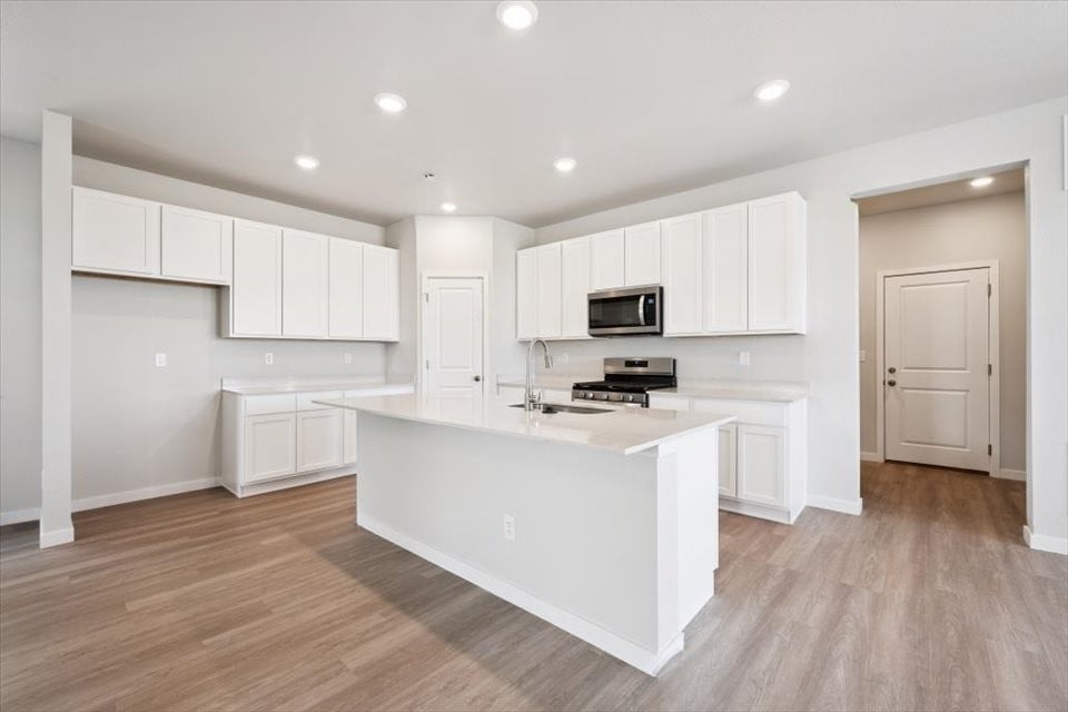 A kitchen with white cabinets.
