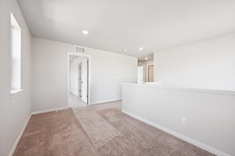 A hallway with a rug.