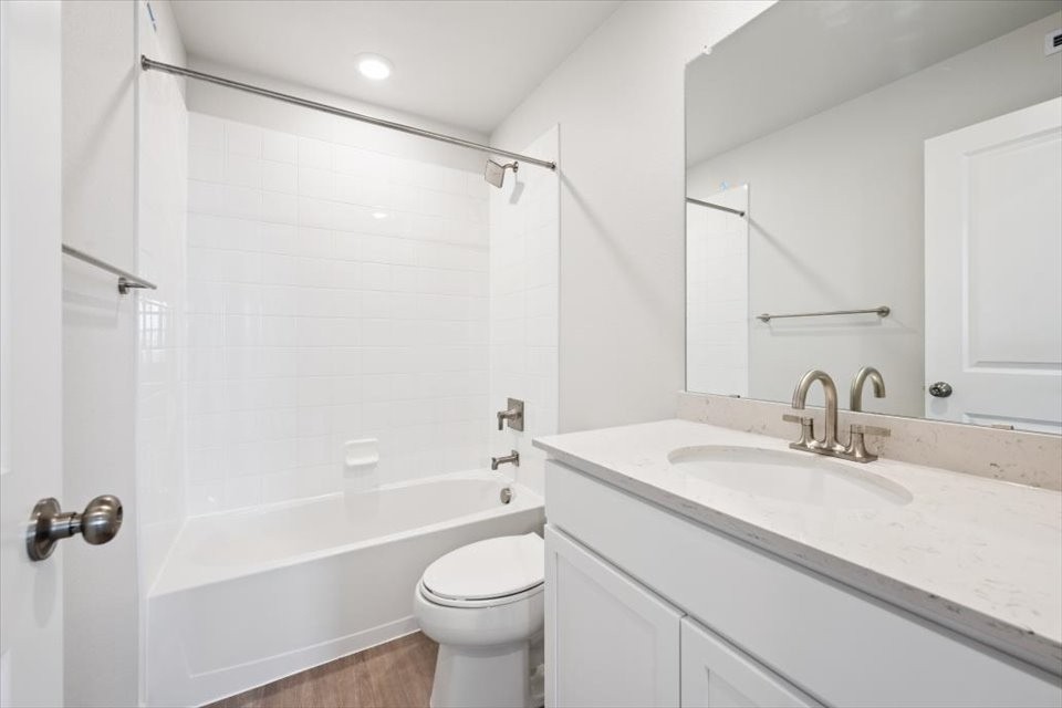 A bathroom with a tub sink and toilet.