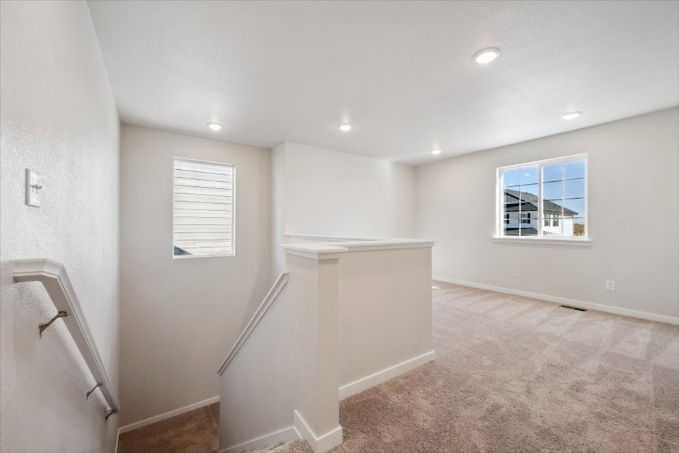 A room with a shower and a window.