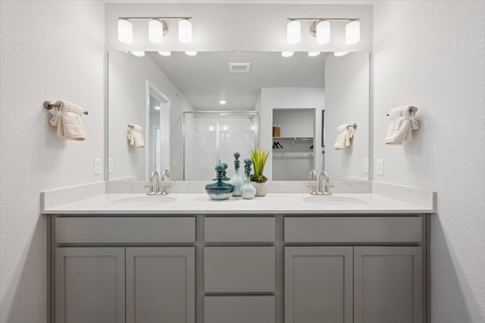 A bathroom with a large mirror.