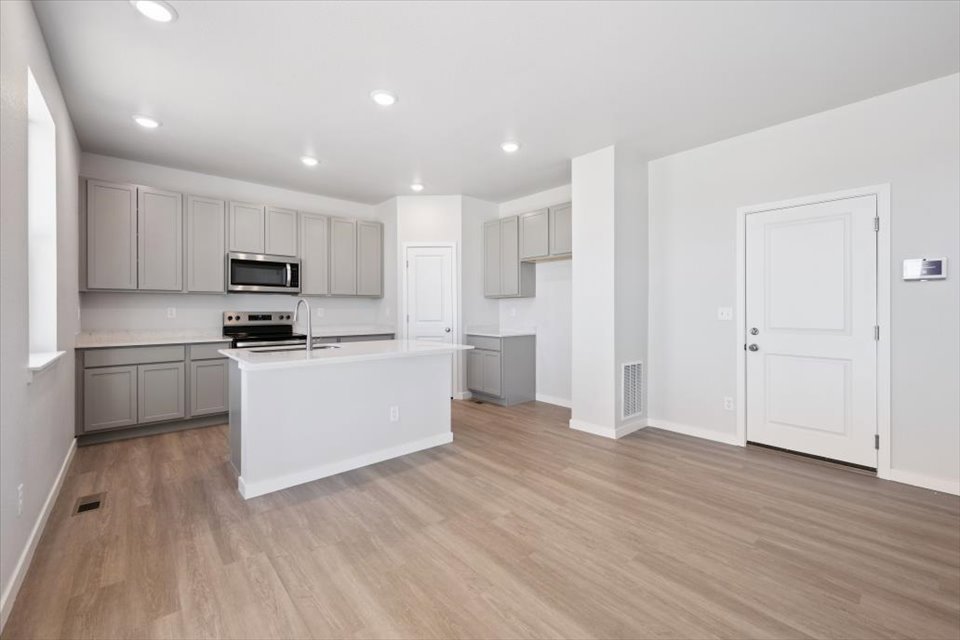 A large kitchen with white cabinets.