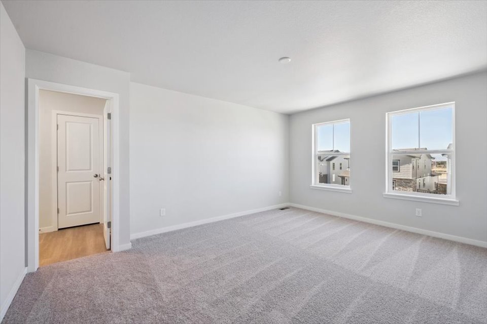 A room with white walls and a door.