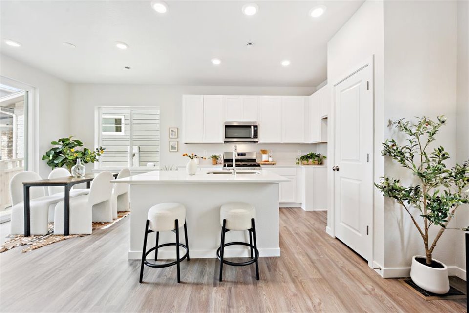 A kitchen with white cabinets.