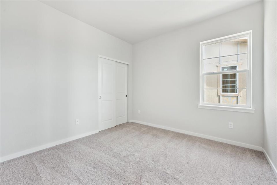 A room with white walls and a window.