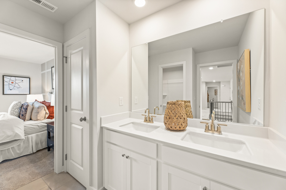 A bathroom with a bed and sink.