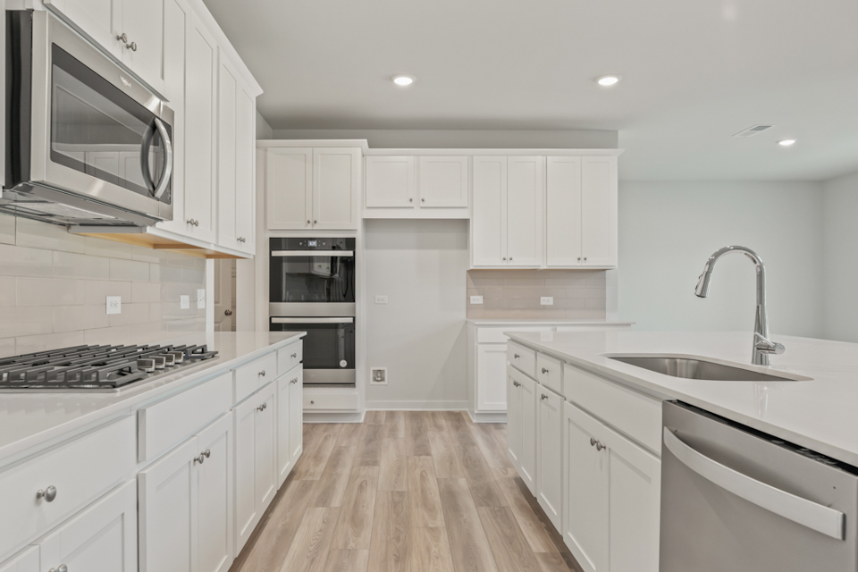 A kitchen with white cabinets.