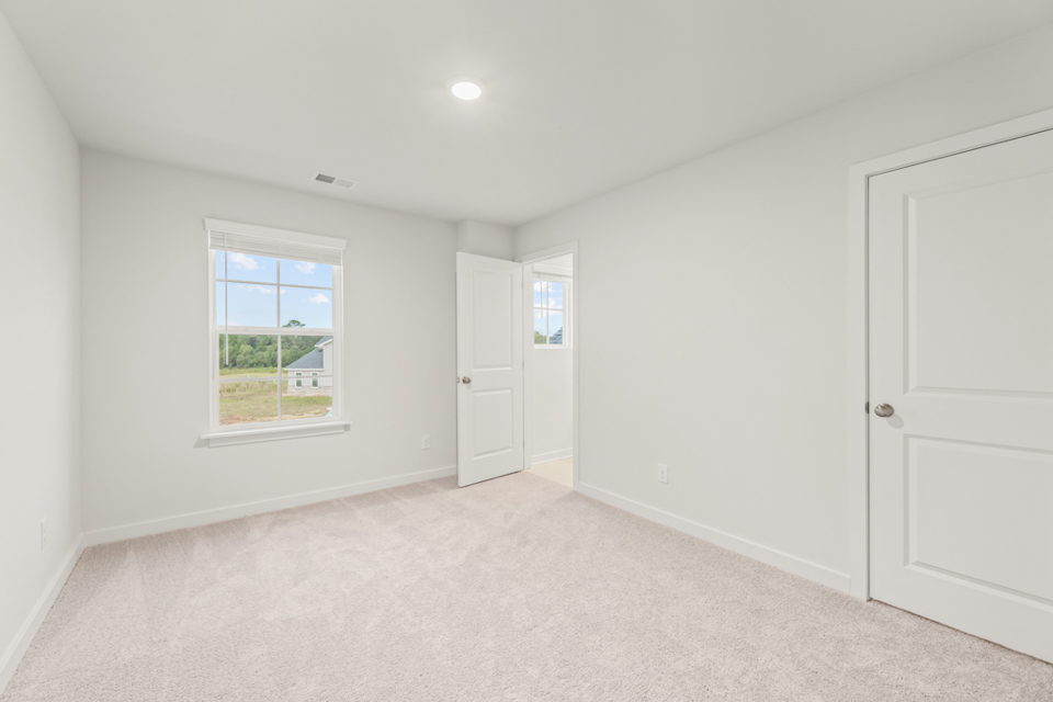 A room with white doors and a window.