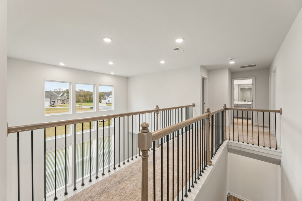 A large white room with a railing.