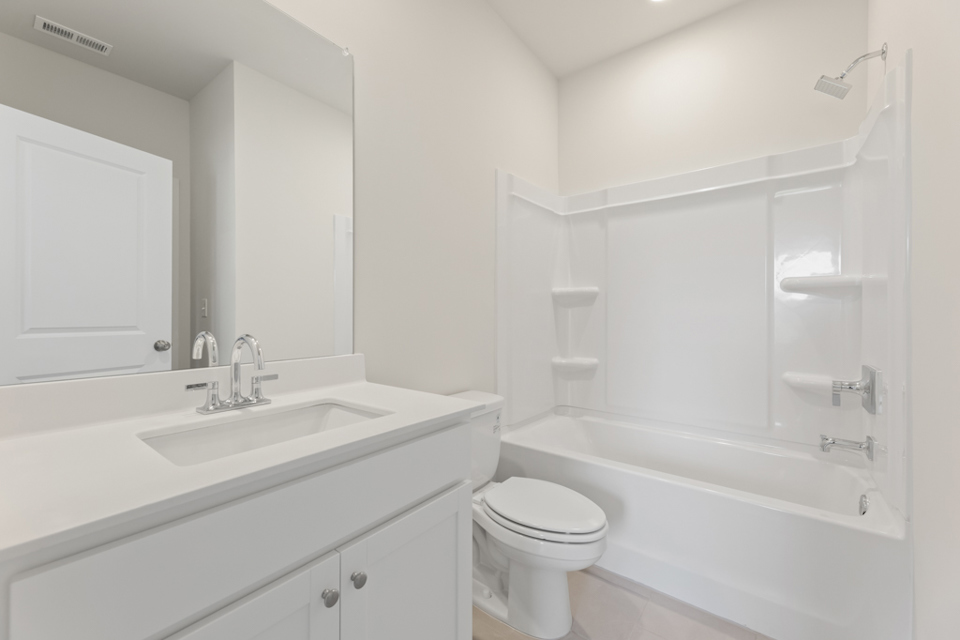 A bathroom with a tub sink and toilet.
