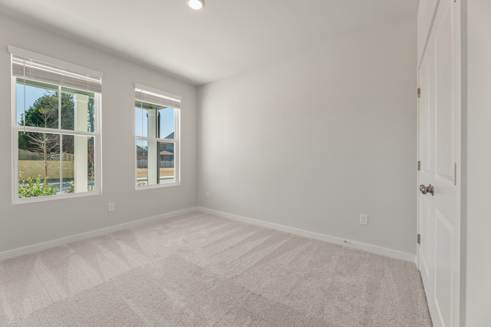 A room with a window and a door.