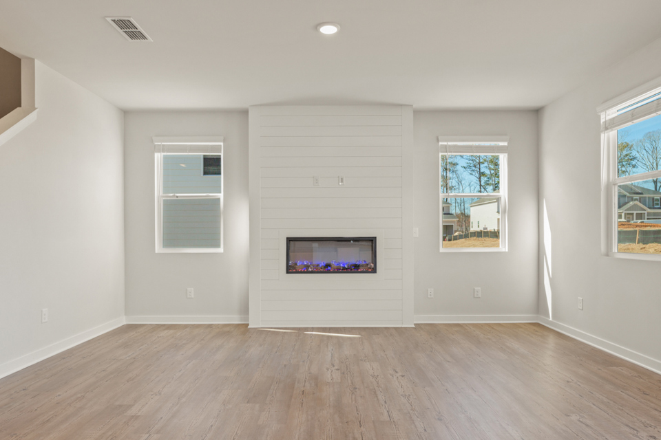 A room with a tv and windows.