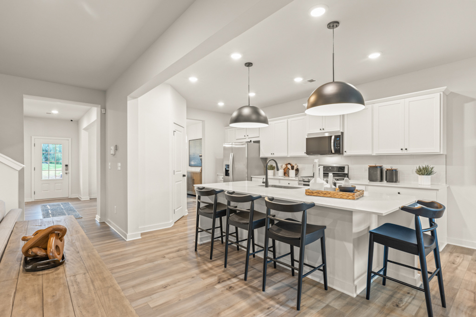 A kitchen with white cabinets.