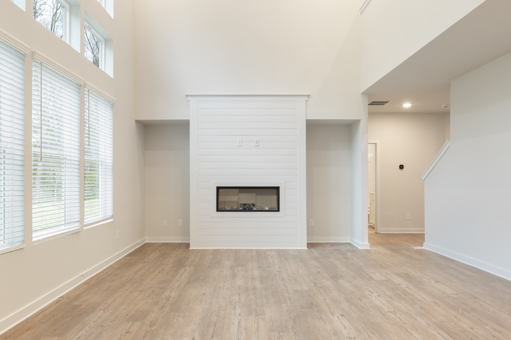 A room with a fireplace and a wood floor.
