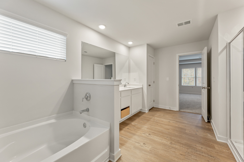 A bathroom with a tub and sink.