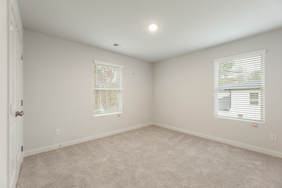 A room with a window and blinds.
