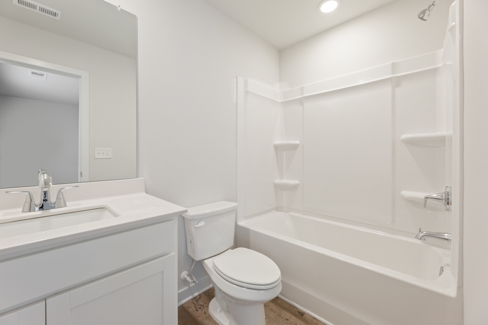 A bathroom with a tub toilet and sink.