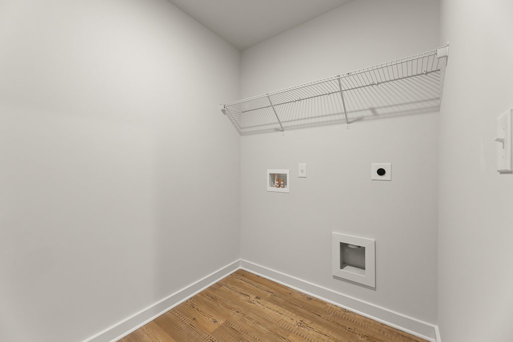 A white room with a wood floor.