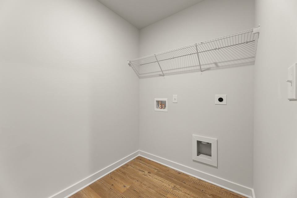 A white room with a wood floor.