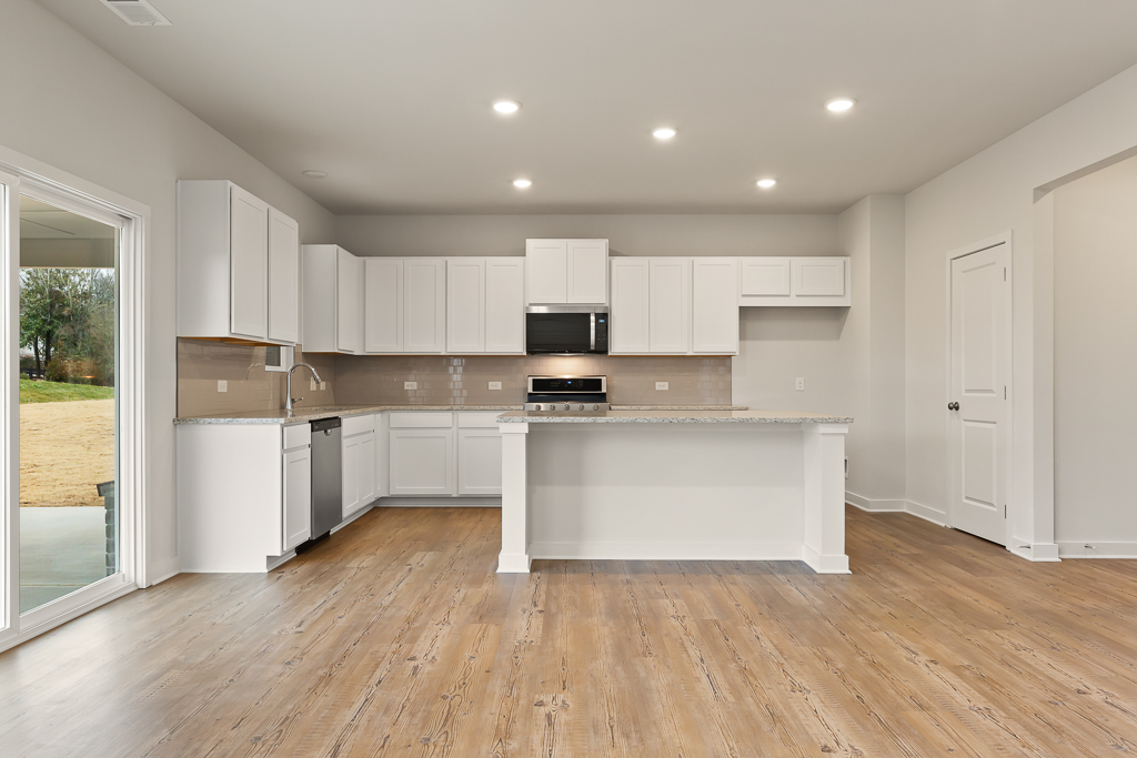 A kitchen with white cabinets.
