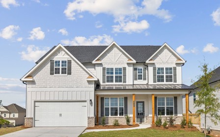A white house with a garage.
