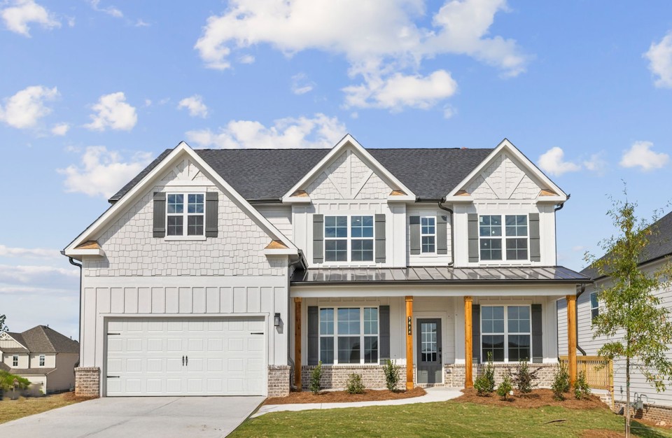 A white house with a garage.