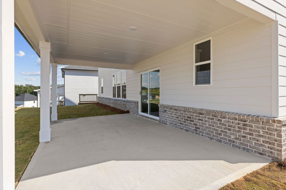 A house with a stone patio.