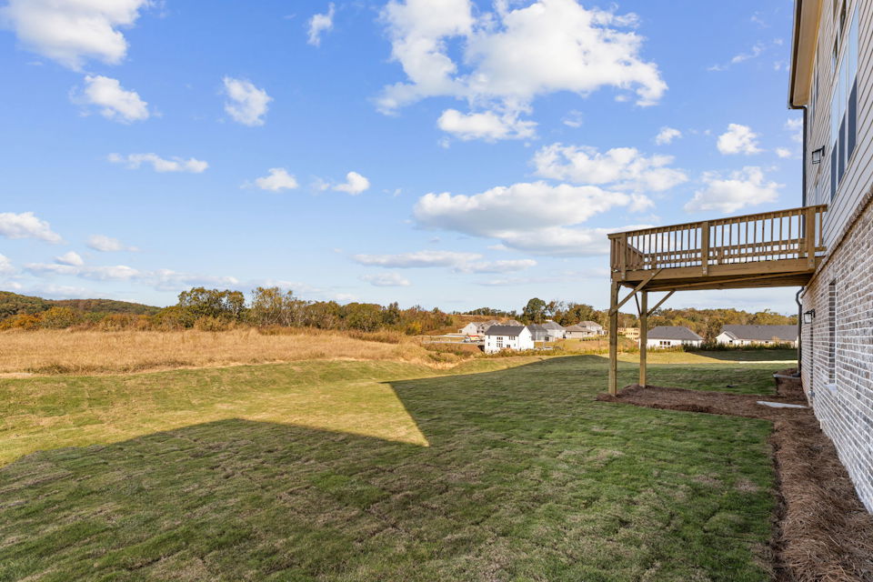 A grassy field with a bridge.