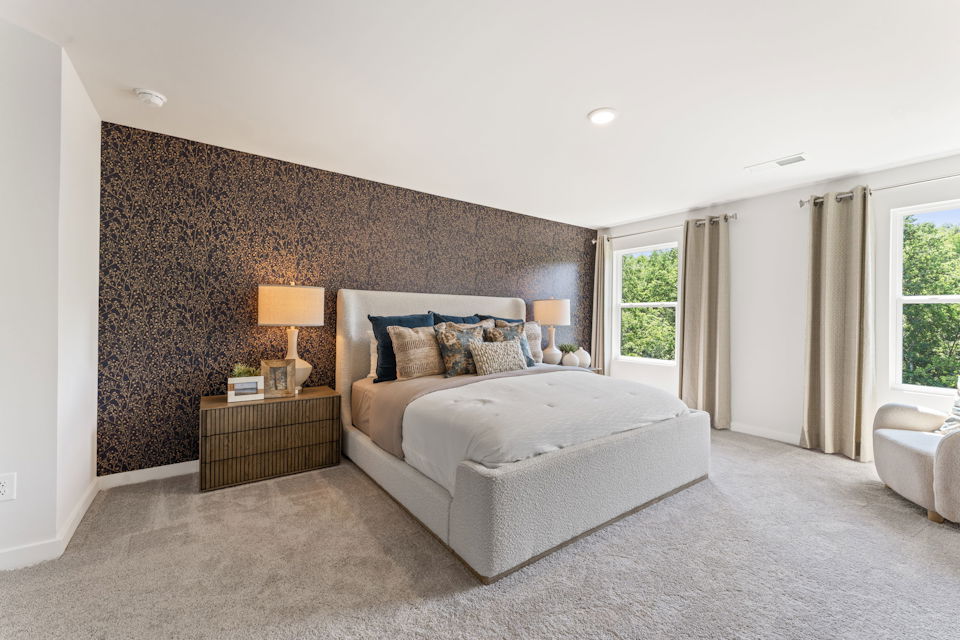 A bedroom with a bed and a couch.