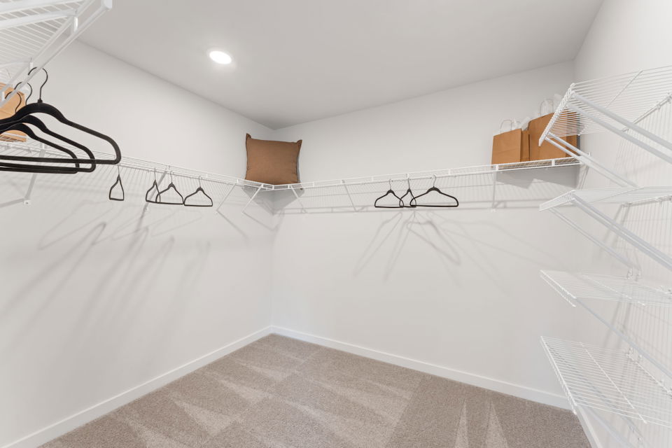 A white bed with a white bed frame.