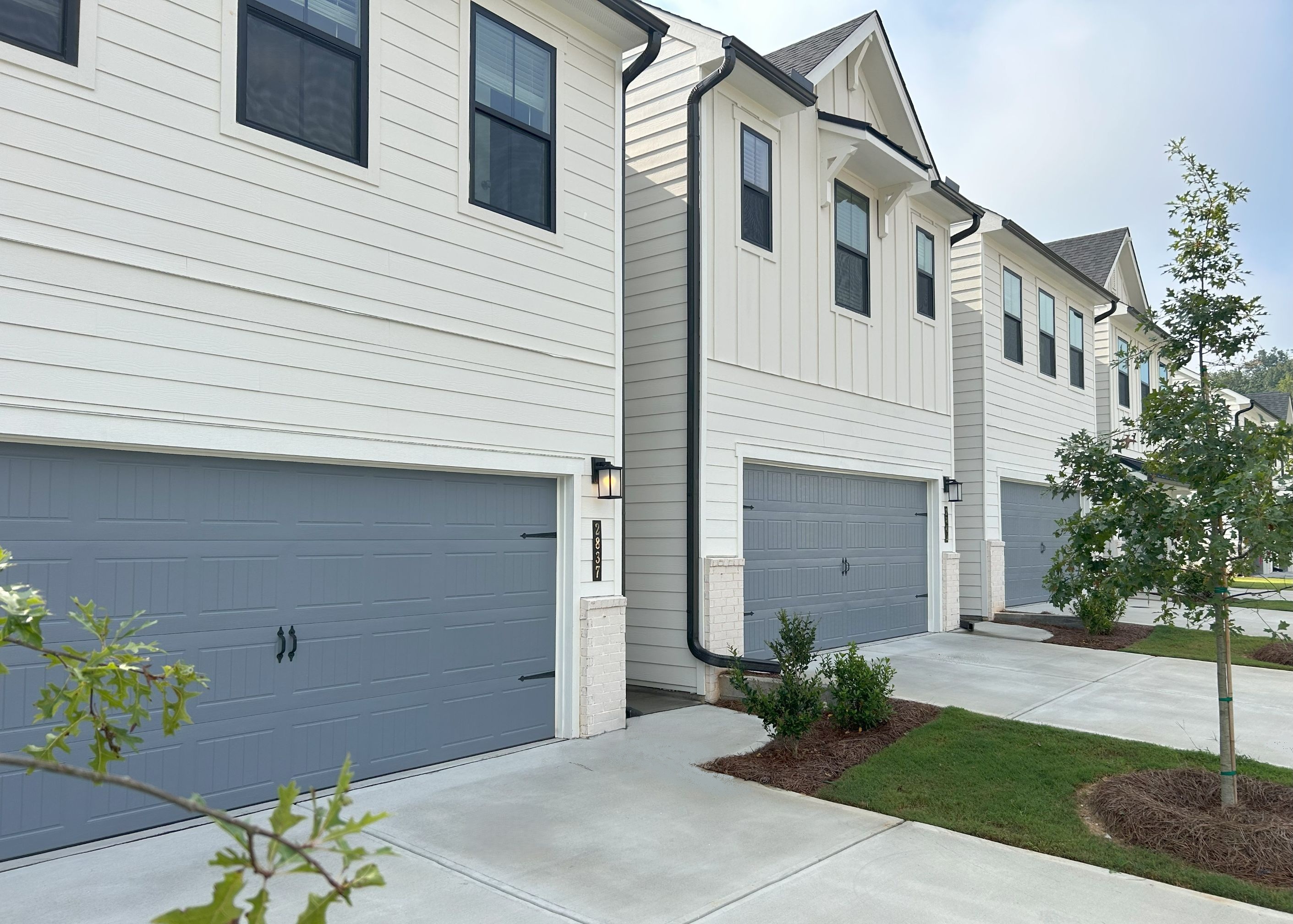 A white house with a garage.