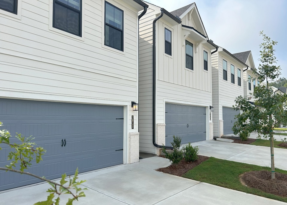 A white house with a garage.