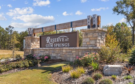 A sign on a stone wall.