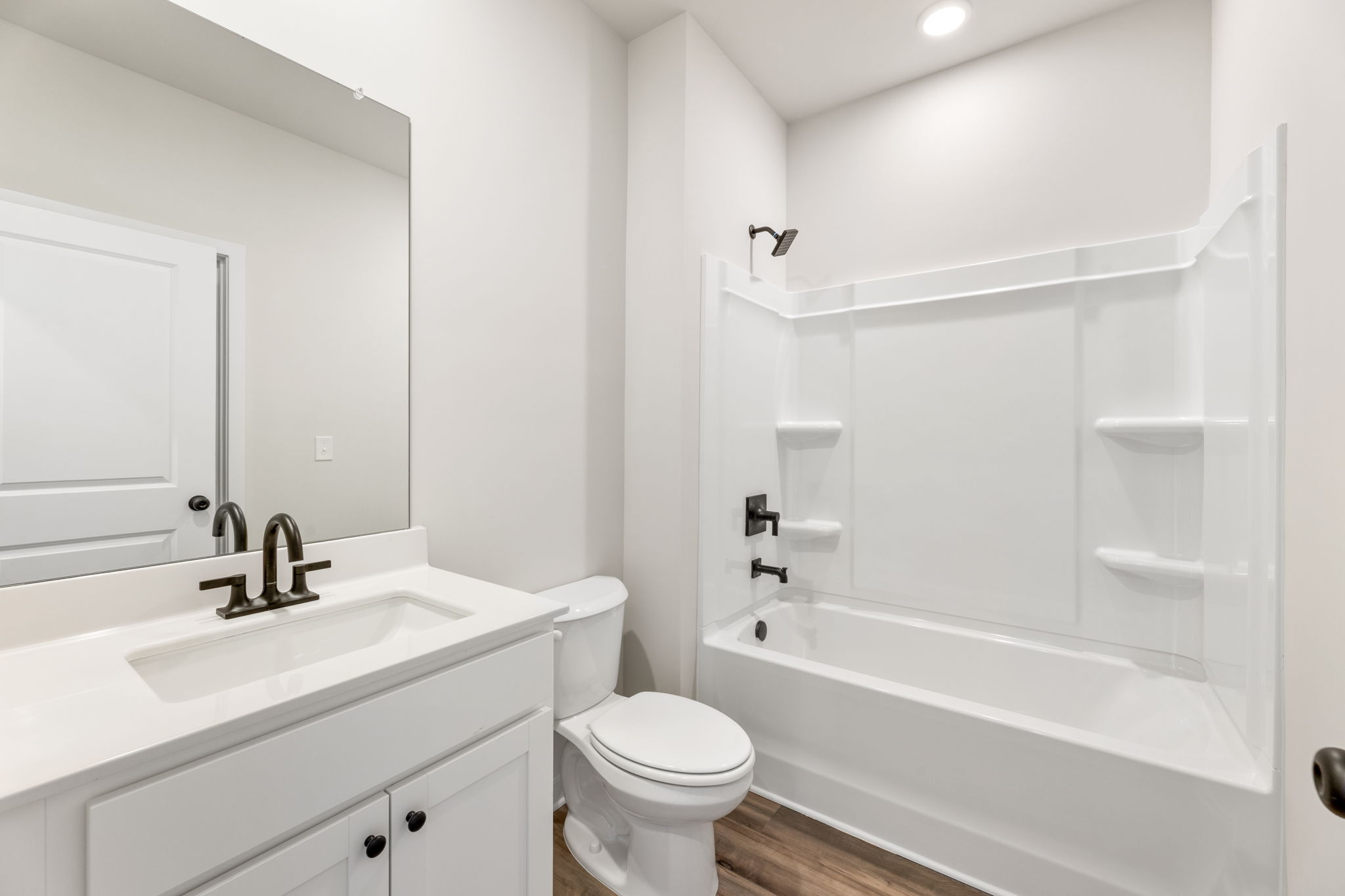 A bathroom with a tub toilet and sink.