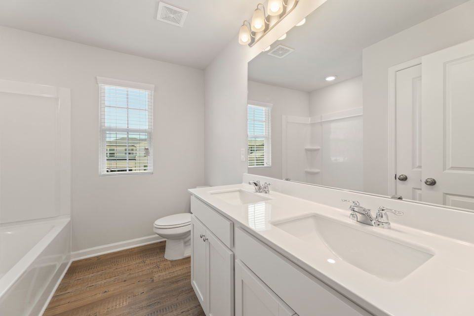 A bathroom with a tub sink and toilet.