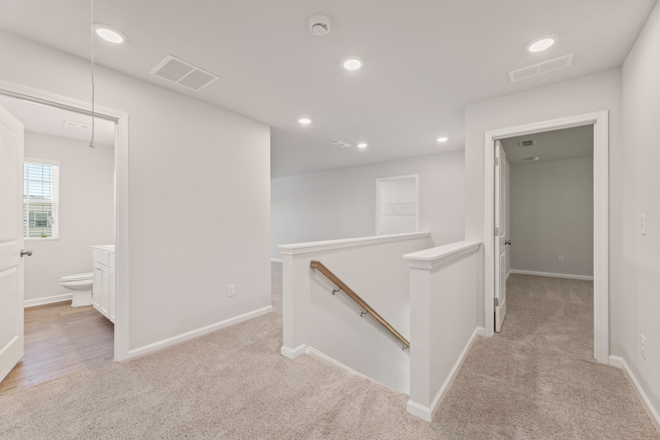 A bathroom with a tub and toilet.