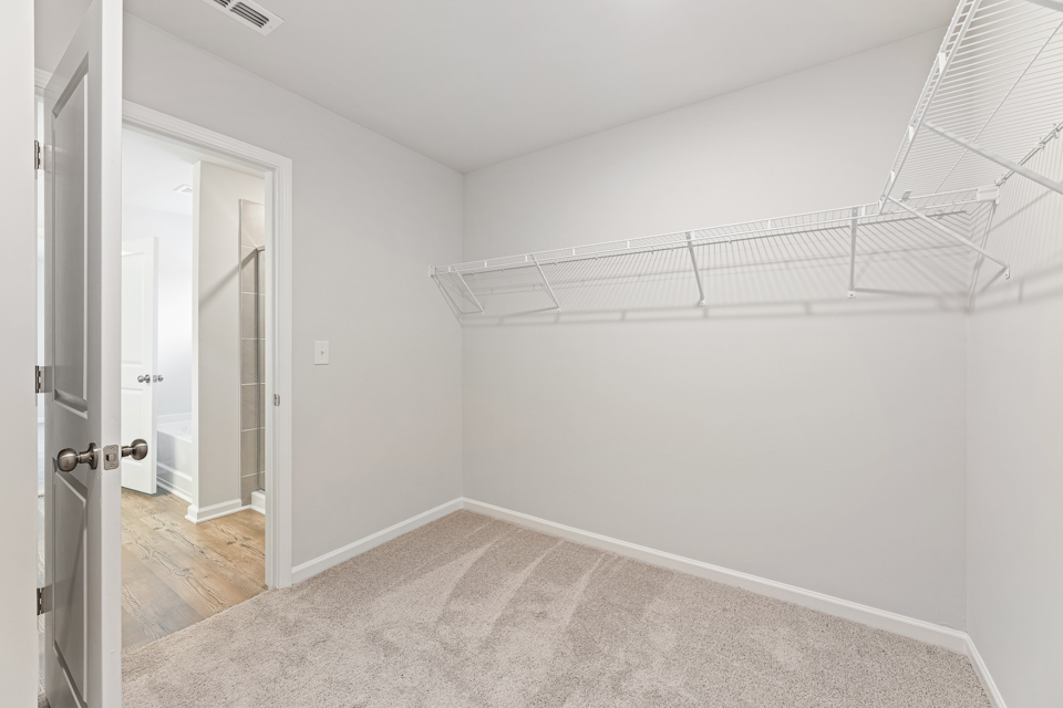 A room with a white wall and a metal railing.