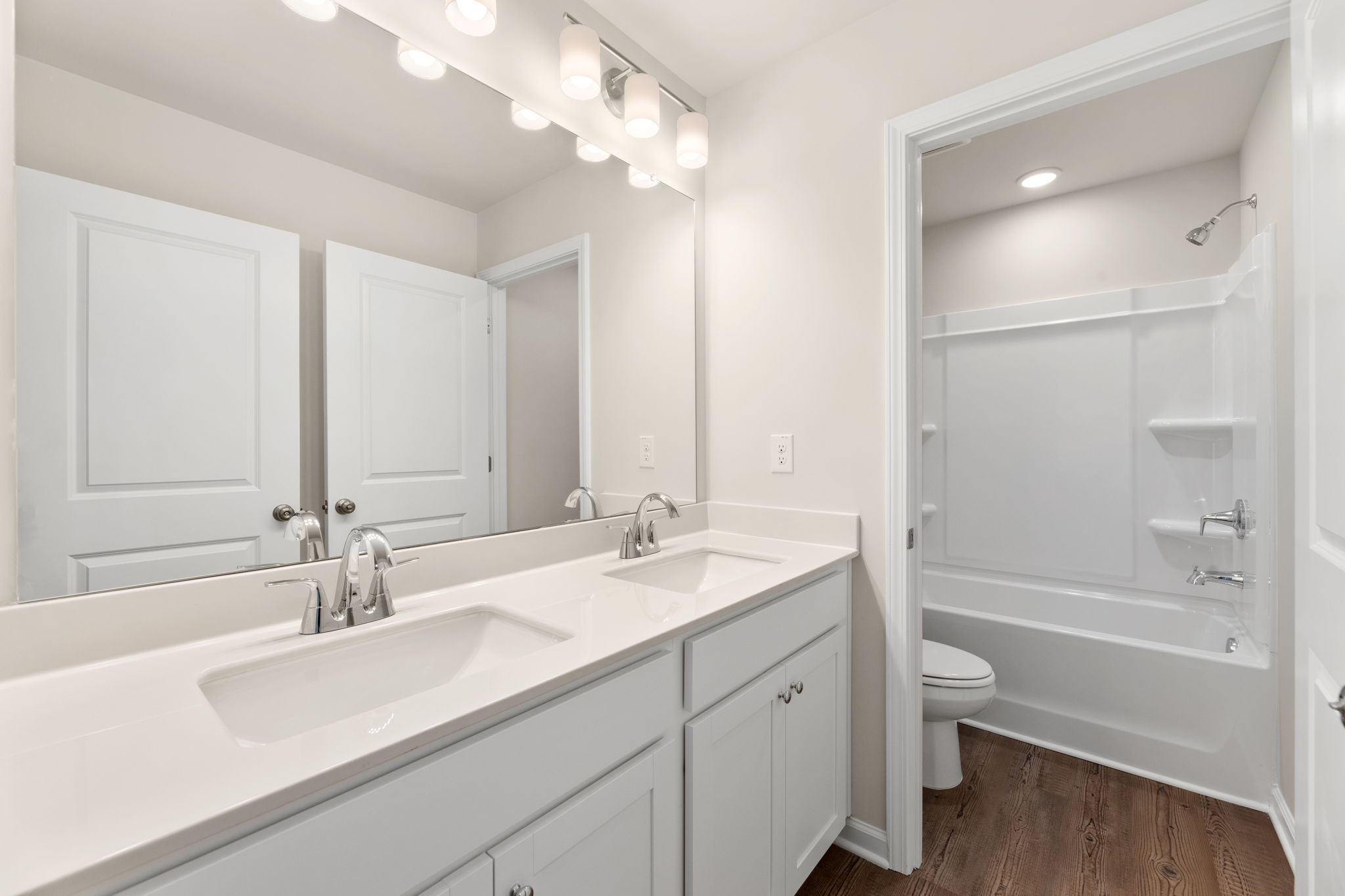 A bathroom with a tub sink and toilet.