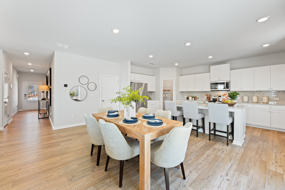 A large kitchen with a dining table.
