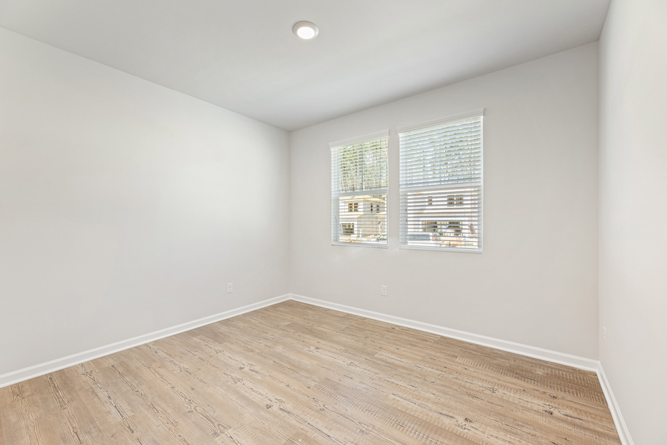 A room with a wood floor and a window.
