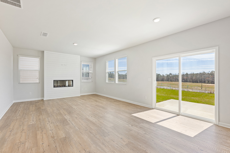 A room with a wood floor and a large window.